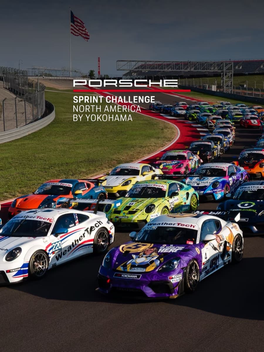 A grid of Porsche race cars lined up on track