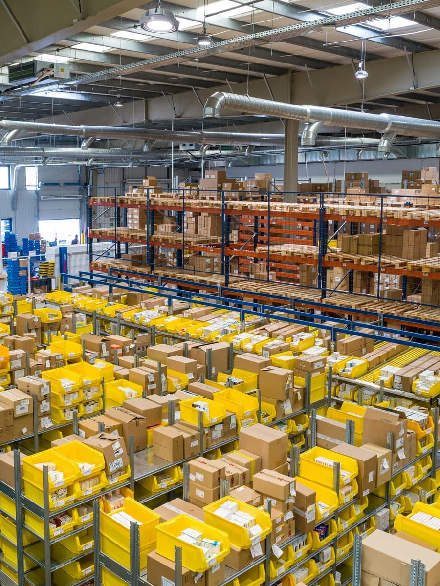 Racking and picking bins across a distribution warehouse